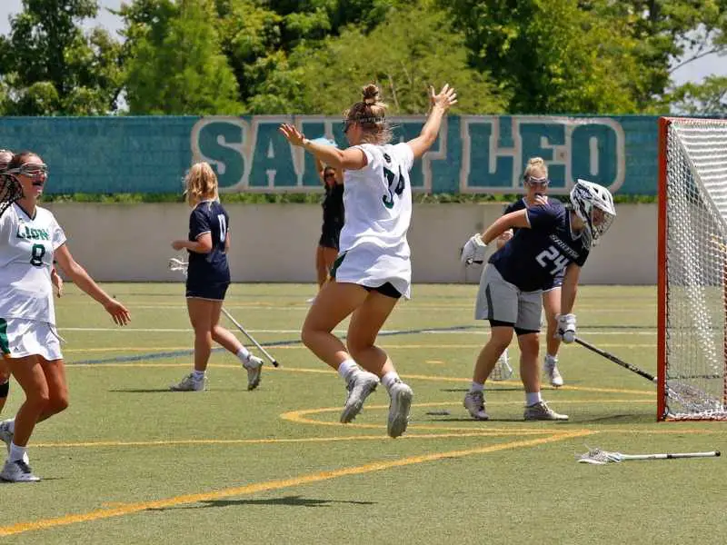 women's lacrosse players throw their sticks